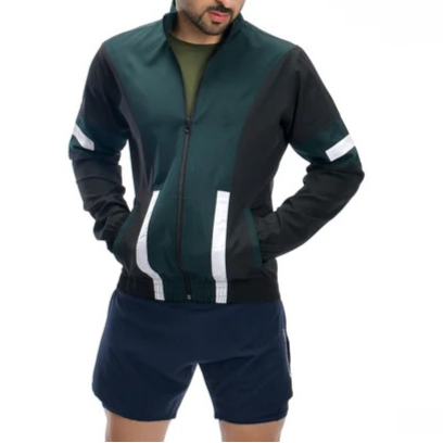 Man wearing a black and green tracksuit with white stripes on a white background