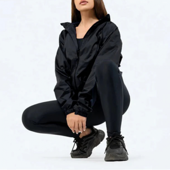 Person wearing a black outfit on a white background